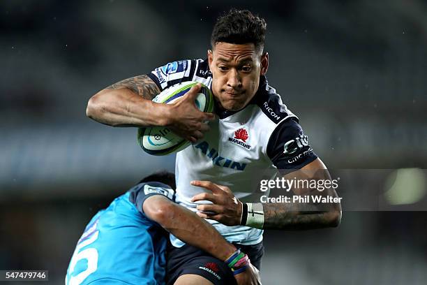 Israel Folau of the Waratahs is tackled by Melani Nanai of the Blues during the round 17 Super Rugby match between the Blues and the Waratahs at Eden...