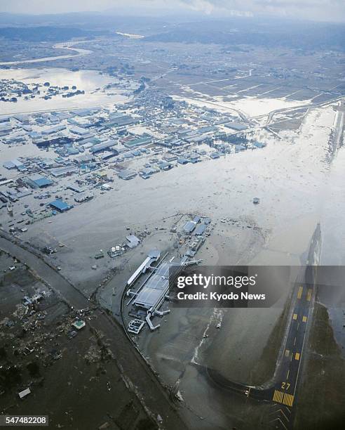 Natori, Japan - Sendai airport and its vicinity are submerged after a tsunami following a powerful quake in a photo taken from a Kyodo News...