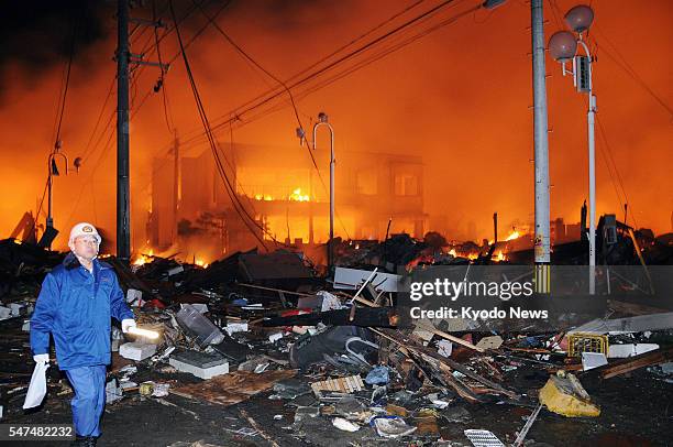 Japan - Houses lie flattened after a powerful earthquake and resulting fires in Iwaki, Fukushima Prefecture, on March 11, 2011.