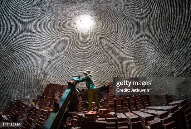 people transport bricks at small local brick making factory - appliance manufacturing stock pictures, royalty-free photos & images