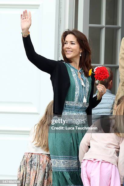 Crown Princess Mary of Denmark waves to the photographers at the annual summer photo call for The Danish Royal Family at Grasten Castle on July 15,...