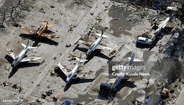 Higashimatsushima, Japan - Aircrafts are covered with mud in the Air Self-Defense Force base in Higashimatsushima in Miyagi Prefecture on March 12 a...