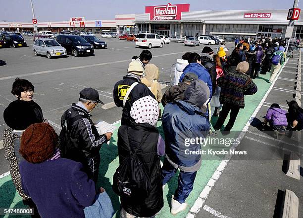 Higashimatsushima, Japan - Customers wait in a long line to enter a supermarket in Higashimatsushima, Miyagi Prefecture, on March 13 when the store...