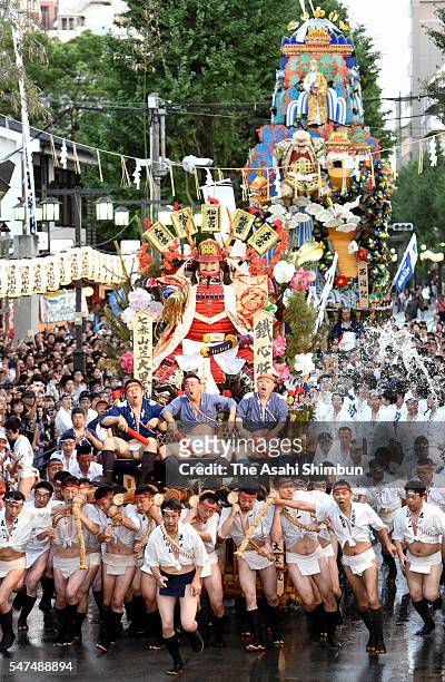 The seventh float 'Daikoku Nagare' rushes through Seido Street of Kushida Jinja Shrine during the Hakata Gion Yamakasa festival on July 15, 2016 in...
