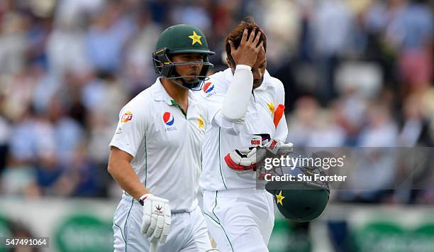 Pakistan batsman Mohammad Amir and batting partner Yasir Shah leave the field after Amir had been dismissed during day two of the 1st Investec Test...