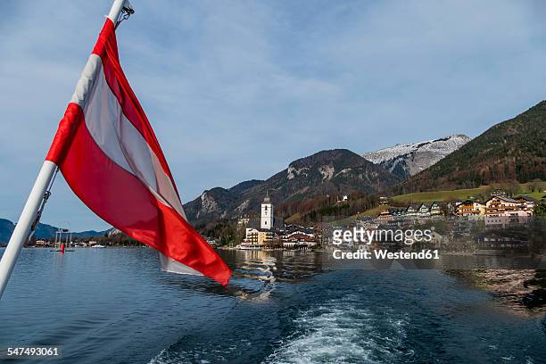 austria, salzburg state, st. wolfgang at wolfgangsee with ensign in the foreground - austria flag stock pictures, royalty-free photos & images
