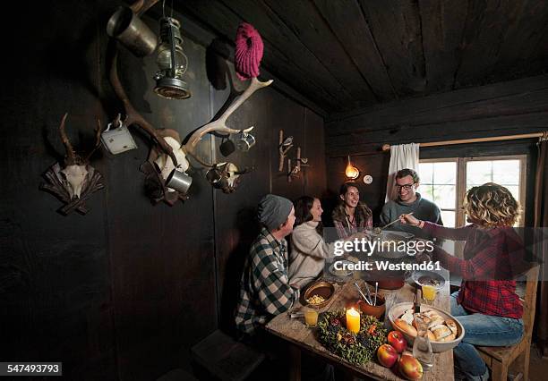 group of young people eating in mountain hut - after ski bildbanksfoton och bilder