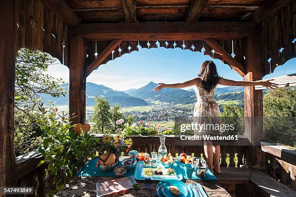 austria, salzburg state, altenmarkt-zauchense, woman enjoying view from veranda of old farmhouse - breakfast with view stock-fotos und bilder