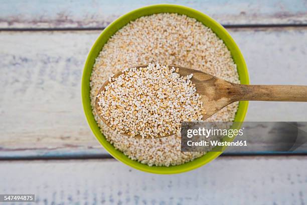popped organic amarant on wood spoon and in bowl - amarant stock pictures, royalty-free photos & images