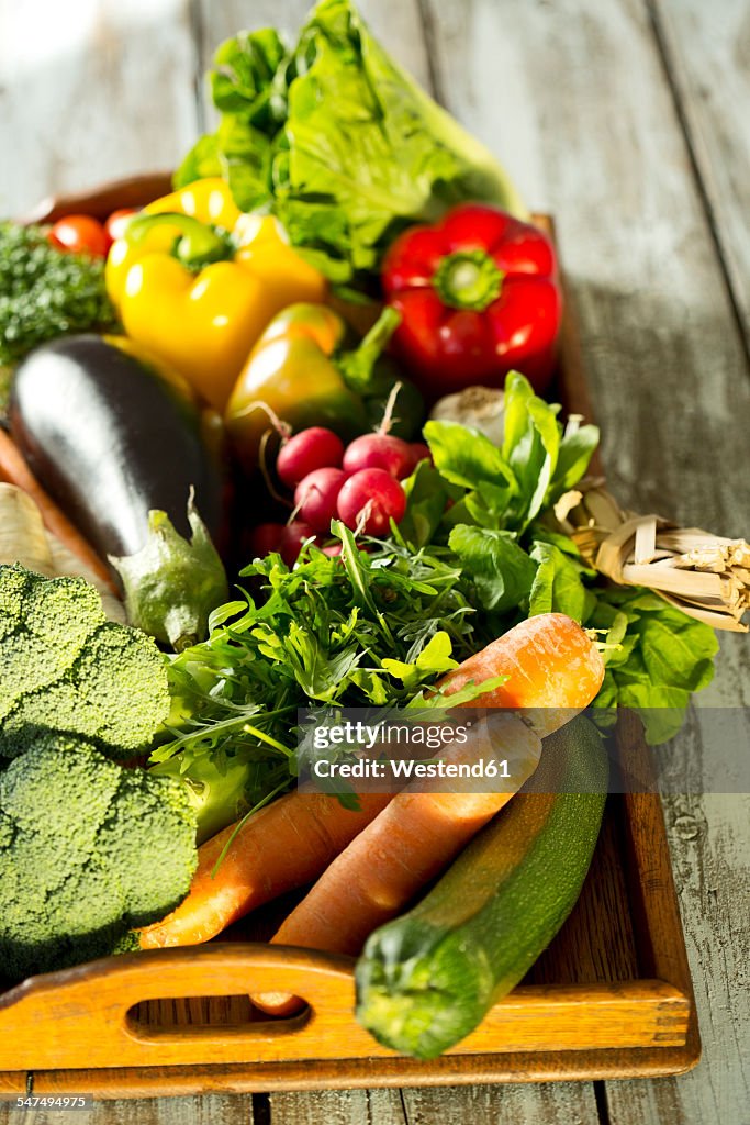 Wooden tray with different vegetables