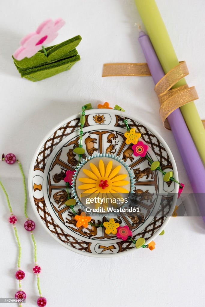 Birthday cup cake on plate with Chinese zodiac signs