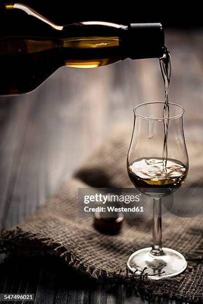 scotch single malt whiskey being poured into nosing glass - nosing around stock pictures, royalty-free photos & images