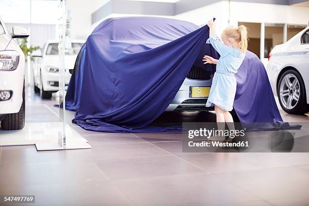 girl at car dealer unveiling tarpaulin - pre launch stock pictures, royalty-free photos & images