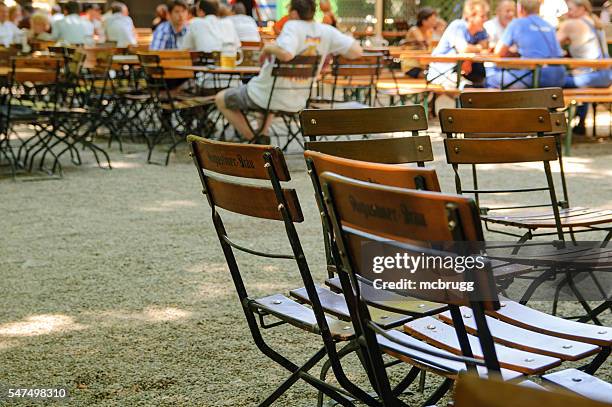 chairs in a beergarden in munich, germany - biergarten münchen stock pictures, royalty-free photos & images