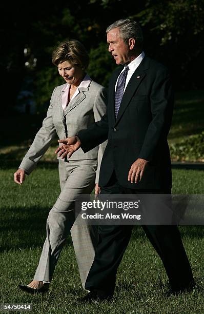 President George W. Bush walks with first lady Laura toward the Marine One prior to their departure from the White House September 5, 2005 in...