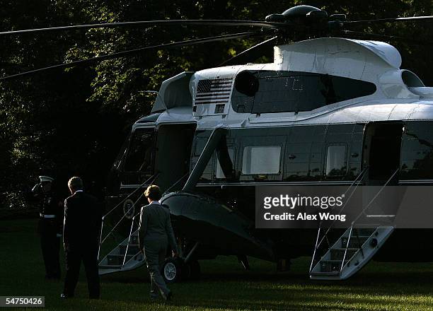President George W. Bush walks with first lady Laura toward the Marine One prior to their departure from the White House September 5, 2005 in...