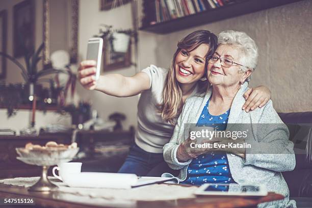 taking selfies - senior young woman stockfoto's en -beelden