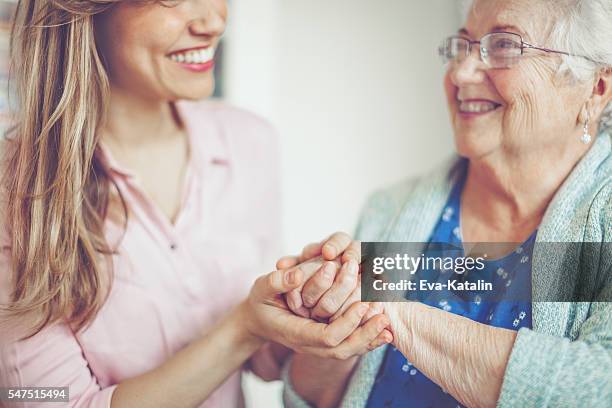 hand in hand - volunteer aged care stock pictures, royalty-free photos & images