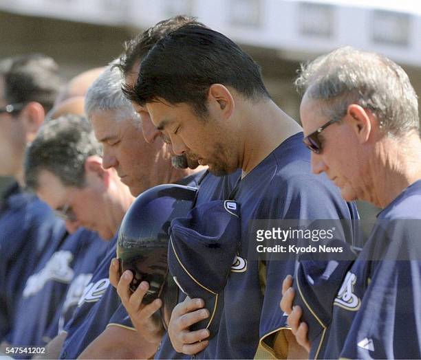 United States - Milwaukee Brewers pitcher Takashi Saito and teammates offer a moment of prayer before a spring training game in Maryvale, Arizona, on...