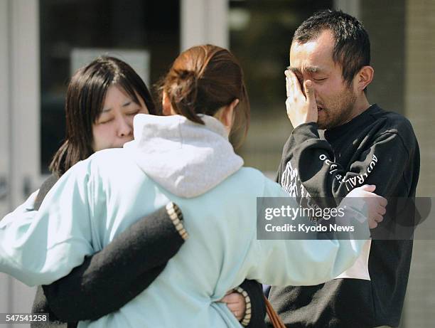 Higashimatsushima, Japan - A man cries after learning of his friend's death in the March 11 mega earthquake, at an evacuation area in...