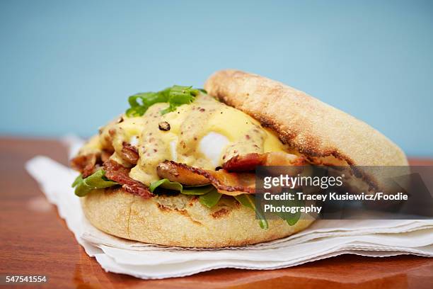 eggs benedict with bacon and a grainy mustard hollandaise - english muffin stock pictures, royalty-free photos & images