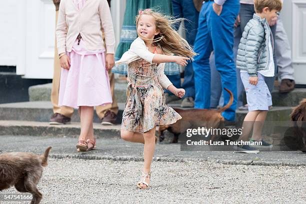 Princess Josephine of Denmark throws a ball for a dog during the annual summer photo call for The Danish Royal Family at Grasten Castle on July 25,...