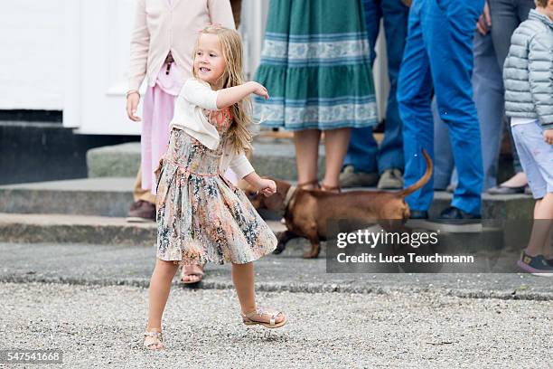 Princess Josephine of Denmark throws a ball for a dog during the annual summer photo call for The Danish Royal Family at Grasten Castle on July 25,...