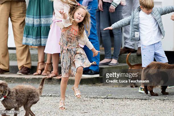 Princess Josephine of Denmark plays with dogs during the annual summer photo call for The Danish Royal Family at Grasten Castle on July 25, 2015 in...