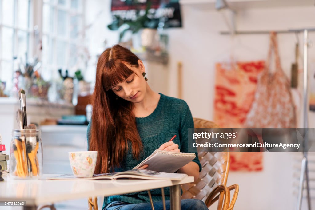 Designer at work table in textile workshop