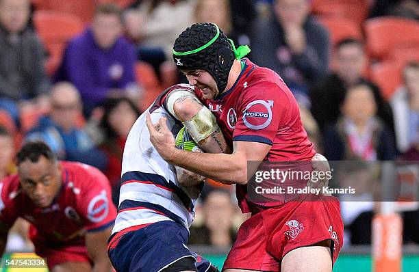 Liam Gill of the Queensland Reds attempts to break free from the defence during the round 17 Super Rugby match between the Reds and the Rebels at...