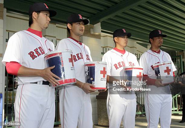 United States - The Boston Red Sox's Japanese players -- Junichi Tazawa, Itsuki Shoda, Daisuke Matsuzaka and Hideki Okajima -- hold charity boxes for...