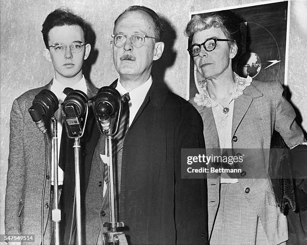 Flanked by his wife and son, David Owen Lattimore whom Senator McCarthy charged with being a Soviet agent, is shown lashing back at his accused...