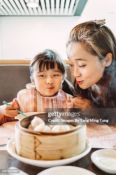 mom & daughter enjoying chinese dim sum dumplings - dim sum meal stock pictures, royalty-free photos & images