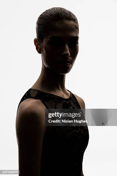 portrait of woman backlit looking at camera - backlight stock pictures, royalty-free photos & images