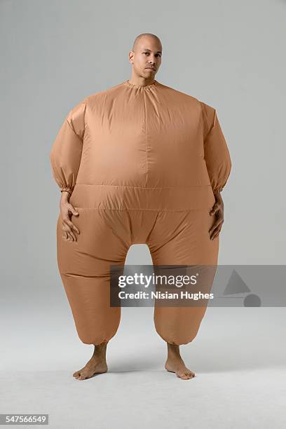 man in balloon suit looking at camera - inflatable stock pictures, royalty-free photos & images