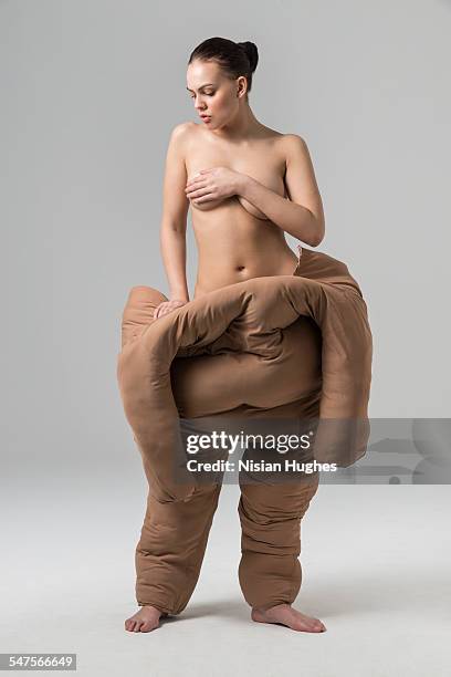 woman pulling off fat suit - weight gain transformation stock pictures, royalty-free photos & images