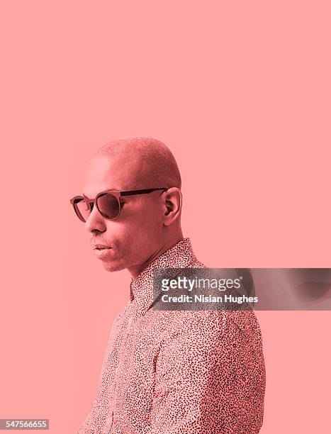 portrait with red filter of man with sunglasses - einfarbig stock-fotos und bilder