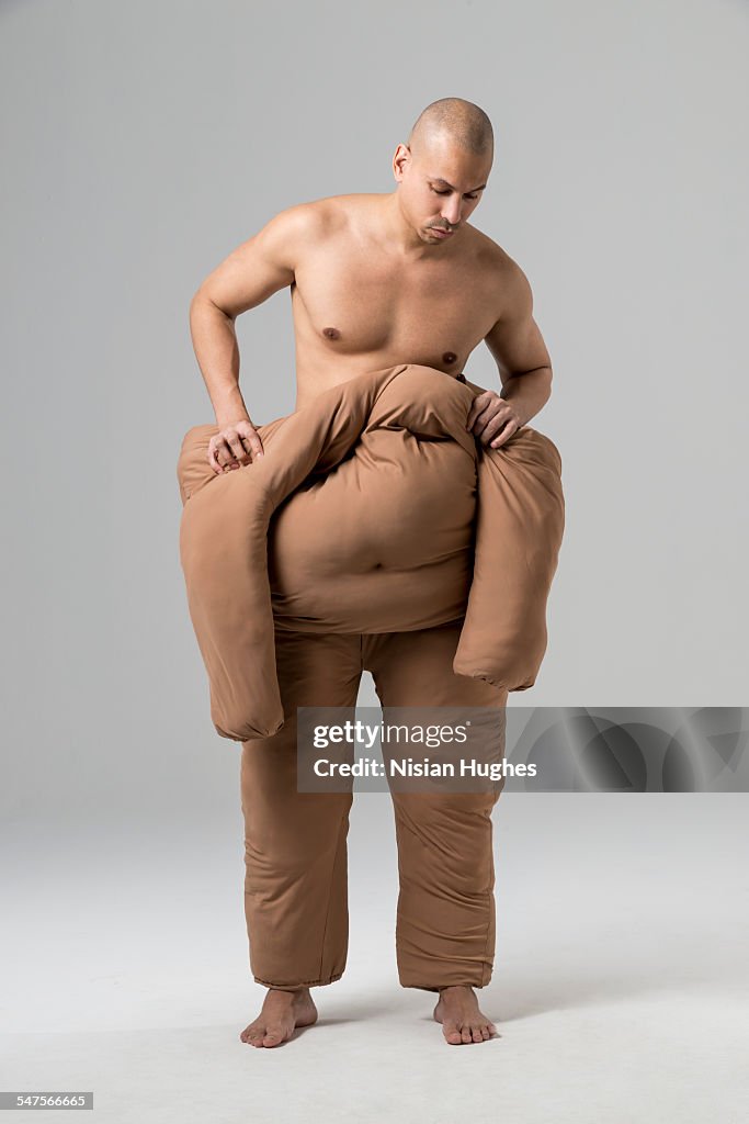 Man pushing off fat suit
