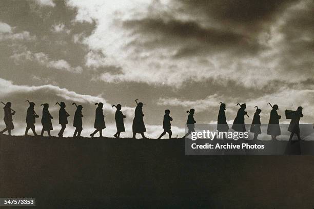 Polish boys return from a day spent working in the fields. The boys were orphaned in the war and are being cared for until they are old enough to...