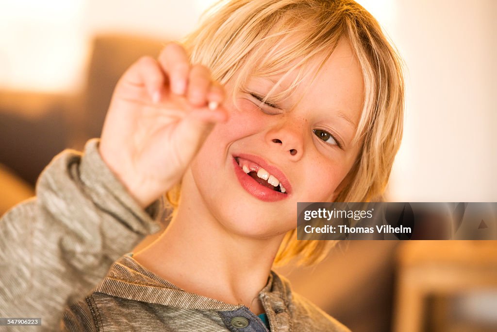 Boy showing missing milk tooth