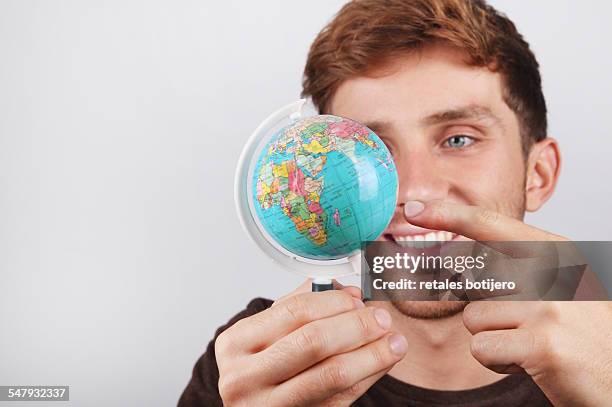 choosing a place on globe. - desk globe stock pictures, royalty-free photos & images