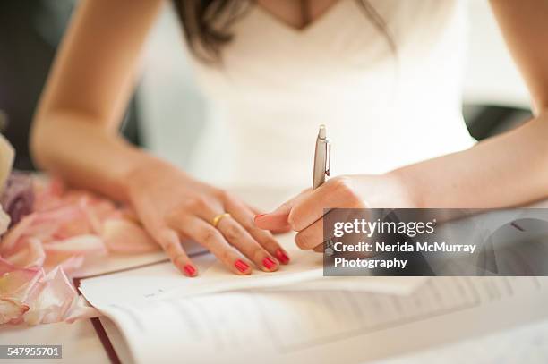 bride signing wedding register - asian bride stock pictures, royalty-free photos & images