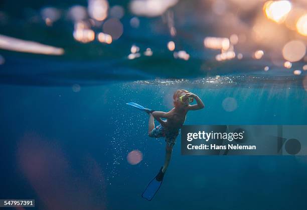 boy snorkeling in the sea, underwater view - child swimming foto e immagini stock