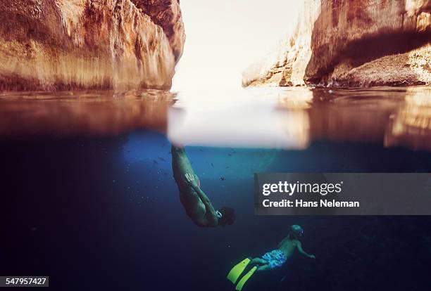 mother snorkeling with son, underwater view - hvar stockfoto's en -beelden