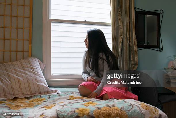 girl looking through the window - breaking up stock pictures, royalty-free photos & images