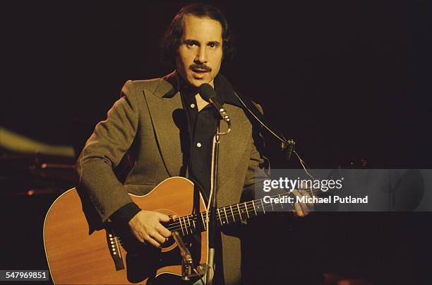 American singer-songwriter Paul Simon performing at the Palladium Theatre, London, December 1975.