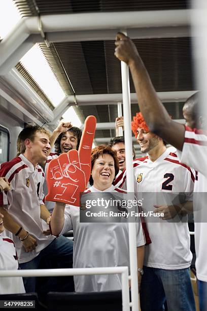 sports fans riding subway - public transport stock-fotos und bilder