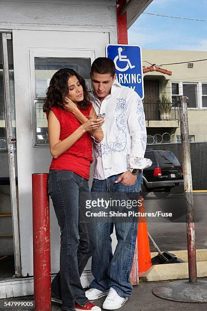 young couple sharing mp3 player - handicap parking space stock pictures, royalty-free photos & images