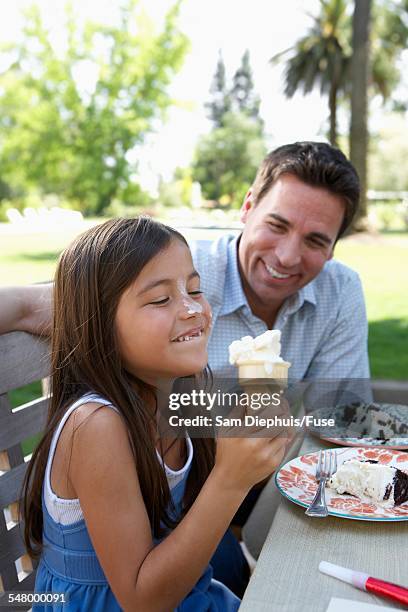 girl eating ice cream cone - girl eating messy ice cream cone stock-fotos und bilder