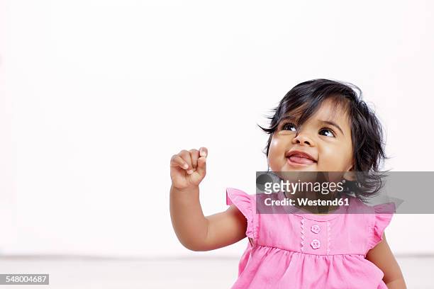 portrait of baby girl looking up - baby girls stock pictures, royalty-free photos & images